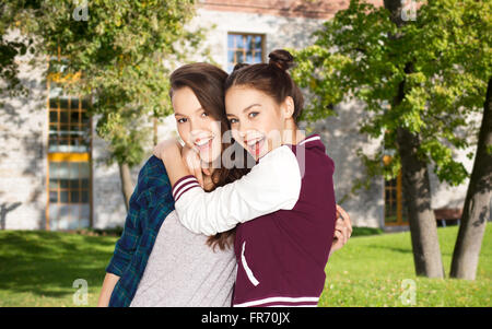 happy teenage student girls hugging over campus Stock Photo