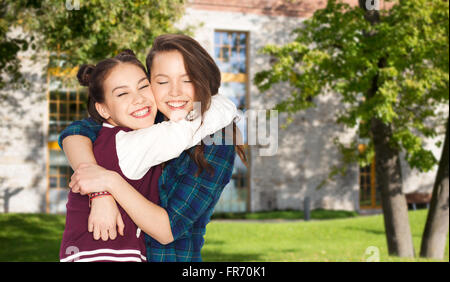 happy smiling pretty teenage student girls hugging Stock Photo