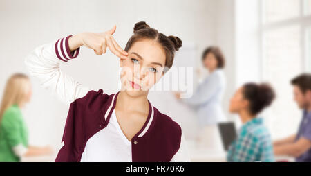 bored student girl making finger gun gesture Stock Photo