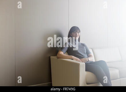 Portrait confident businesswoman on sofa Stock Photo