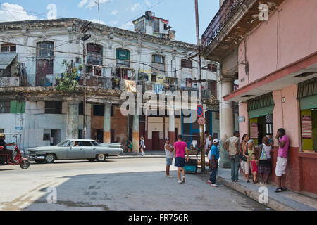 A vintage car drives through the streets of Old Havana, Cuba. Stock Photo