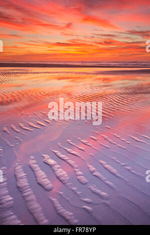 Beautiful sunset over sea with reflection in water, majestic clouds in ...