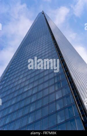 Close up view of The Shard, London Bridge,looking up from the bottom, set against blue sky Stock Photo
