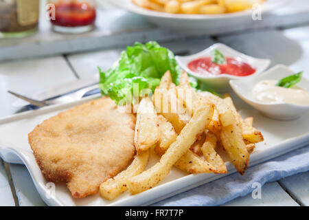 deep fried breaded chicken with salad and french fries Stock Photo