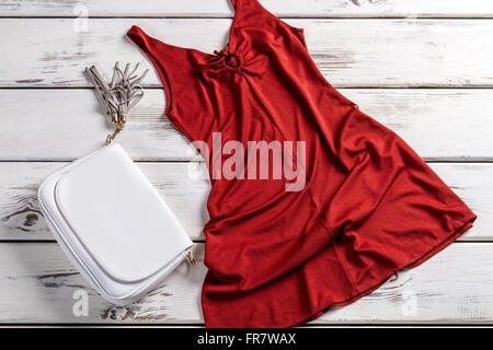 Red dress and leather purse. Stock Photo