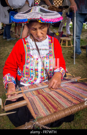 WASHINGTON, DC, USA - Woman demonstrates weaving by hand with backstrap loom (awana), 2015 Smithsonian Folk Life Festival Stock Photo
