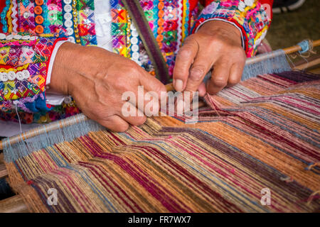 WASHINGTON, DC, USA - Woman from Cusco, Peru demonstrates weaving with backstrap loom (awana), during 2015 Smithsonian Folk Life Stock Photo