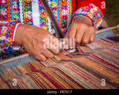 WASHINGTON, DC, USA - Woman demonstrates weaving with backstrap loom (awana), during 2015 Smithsonian Folk Life Stock Photo