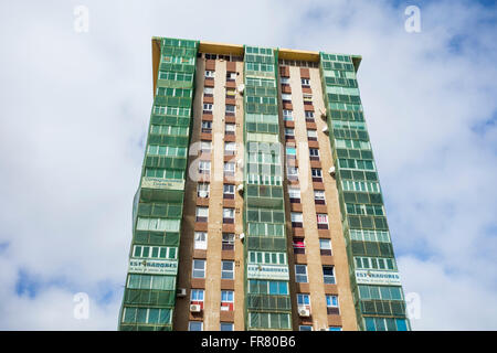 Green netting covering balconies to contain falling masonry on old apartment block in Las Palmas, Gran Canaria, Stock Photo