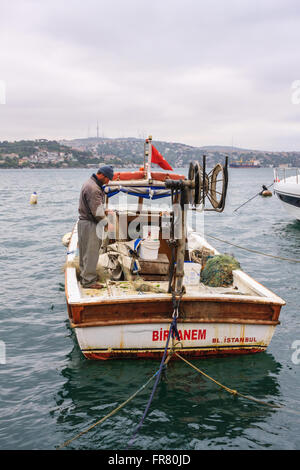 Local fisherman preparing to sail on the river Bosphorus Istanbul Turkey Stock Photo