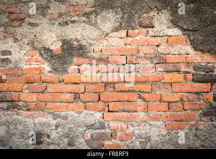 Old dark brown brick wall with crack from fire burning Stock Photo