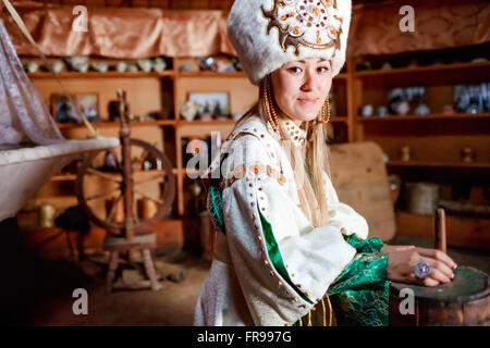 Young woman in traditional yurt dwelling. Stock Photo