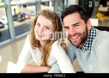Beautiful couple in love sitting in cafe taking selfies Stock Photo