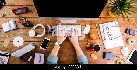 Business person working at office desk wearing smart watch Stock Photo