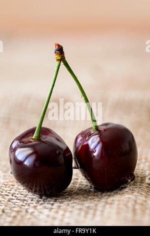 cherries with water drops on jute Stock Photo