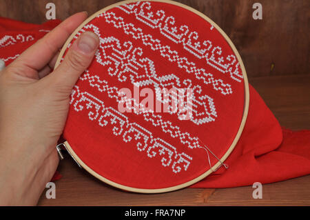 Pattern cross on a red fabric in the hoop Stock Photo