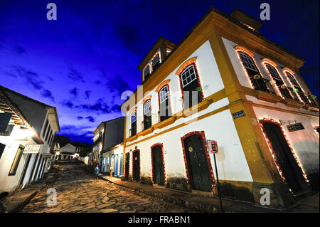 Colonial houses decorated with lights at night Stock Photo