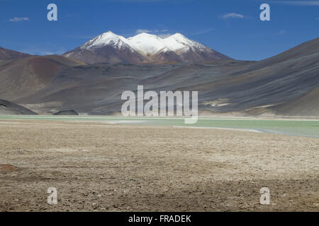 Lagoon and volcano in the region of Piedras Rojas in the Salar de Talar - Atacama Desert Stock Photo