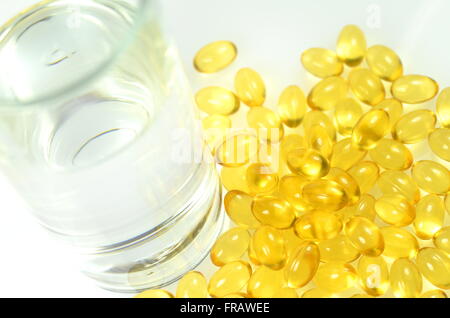 fish oil capsules and a glass of water Stock Photo