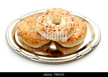 Three Stacked Everything Bagels on a Platter Stock Photo