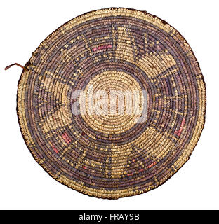 A studio photo of a shallow woven Egyptian basket used for wind winnowing grain Stock Photo