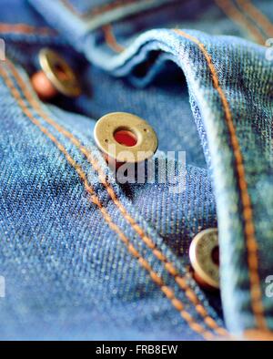 Front piece of the blue jeans. Open buttons fly. Button macro. Jeans button. Stock Photo