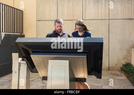 A couple read about the Oklahoma City bombing at the bombing memorial in Oklahoma City, Oklahoma, USA. Stock Photo