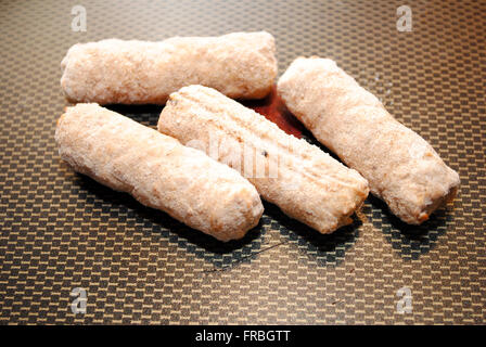 Closeup of Frozen Sausage Links in a Fry Pan Stock Photo