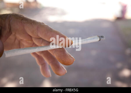 Elderly crafted cigarette smoking Stock Photo
