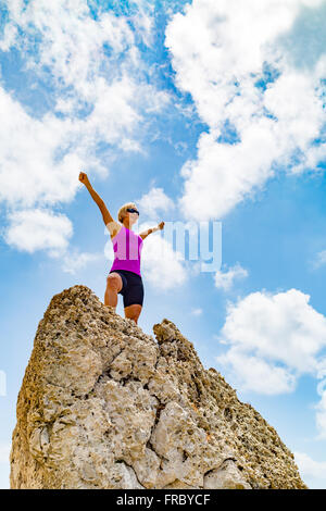 Success achievement  running or hiking accomplishment business concept, woman celebrating with arms up raised. Hands outstretche Stock Photo