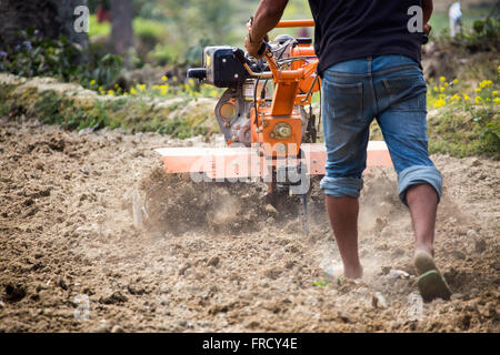 Farmer using a mini tiller in Nuwakot, Nepal Stock Photo