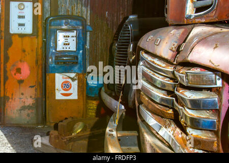 Columbia, VA, USA - March 12, 2016:  Dented front end of old rusting Ford truck in garage with antique gas pupms. Stock Photo