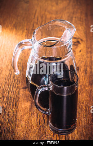 Russian brew in mug and jug of rye  flour on wooden background Stock Photo