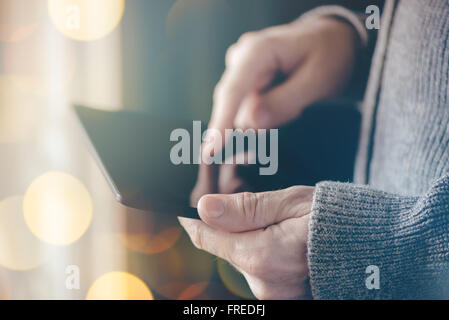 Man using digital tablet computer, casual ordinary adult caucasian man with wireless gadget browsing internet, selective focus Stock Photo