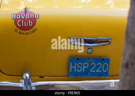 Havana Club El Ron de Cuba badge on back of yellow Chevrolet car HSP220 at Havana, Cuba, West Indies, Caribbean, Central America - Chevrolet logo Stock Photo