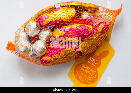 Net of M&S bunnies & bobtails, white chocolate bunnies & milk chocolate bunny tails isolated on white background - ready for Easter Stock Photo