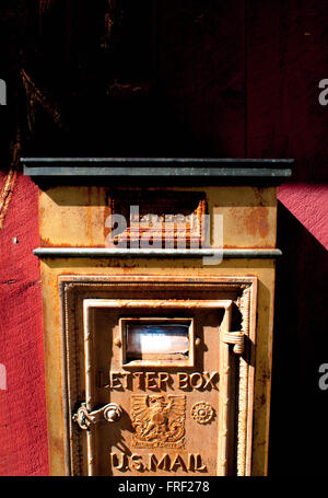 An old metal letter box on the wall of a red barn in Temple, New Hampshire, USA. Stock Photo