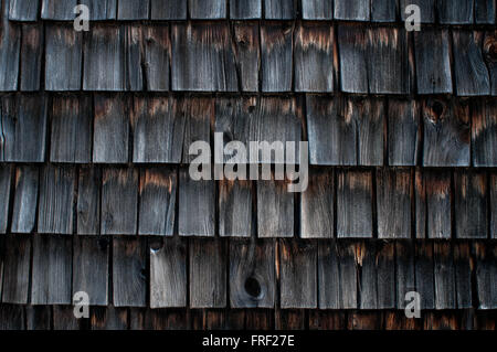 Weathered wooden shingles on an old mill building. Stock Photo