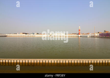 View across the large sarovar at Tarn Taran Gurdwara in Punjab,  India with white marble walkway under a blue sky in springtime Stock Photo