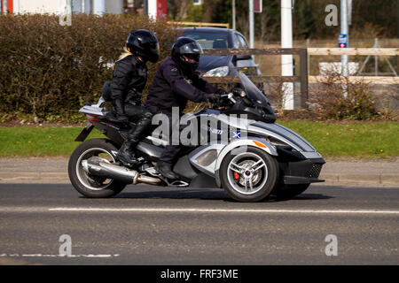 Two people on a three-wheeled Can-Am Spyder Roadster motorcycle travelling along the Riverside in Dundee, UK Stock Photo