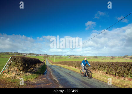 A cyclist cycling near Eaglesham, East Renfrewshire Stock Photo