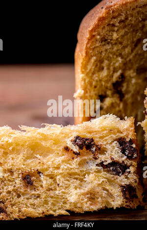 chocolate panettone sliced on wood traditional dessert for christmas in Italy Stock Photo