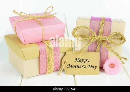 Handmade gift boxes with Happy Mother's Day tag on white wood Stock Photo