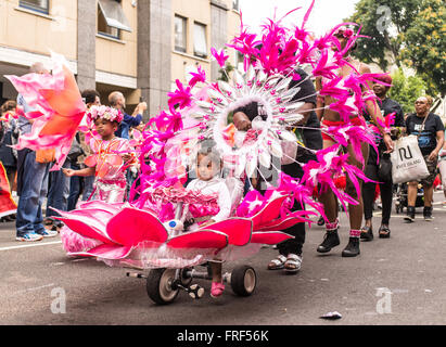Girl on a fancy dressed trike during Notting Hill Carnival street parade, one of the biggest street festival in Europe Stock Photo