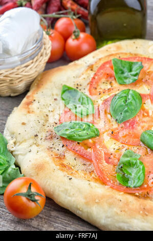 Fresh tomatoes and basil leaves pizza Stock Photo