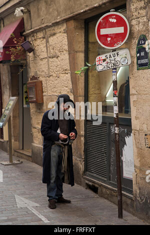 Alcoholic with bottle of whisky in Paris France in winter Stock Photo