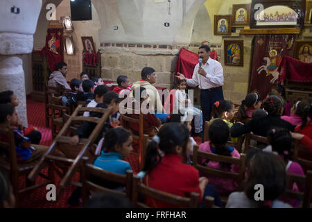 A morning religious lesson held for local Christian children at St Tawdros (St Theodore's) Coptic Orthodox Christian Monastery, Luxor, Nile Valley, Egypt. The Copts are an ethno-religious group in North Africa and the Middle East, mainly in the area of modern Egypt, where they are the largest Christian denomination. Christianity was the religion of the vast majority of Egyptians from 400–800 A.D. and the majority after the Muslim conquest until the mid-10th century. Today, there are an extimated 9-15m Copts in Egypt. Stock Photo