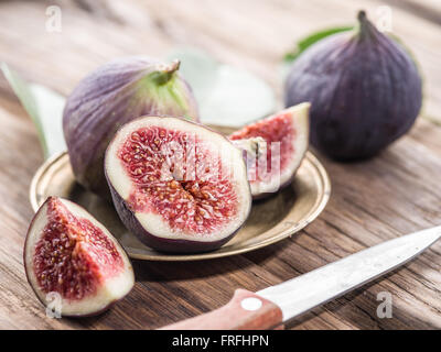Ripe fig fruits on the wooden table. Stock Photo