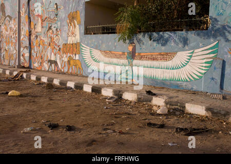 Modern hieroglyphic artwork painted on a wall of local wasteground in the village of Gezirat on the West Bank of Luxor, Nile Valley, Egypt. Stock Photo
