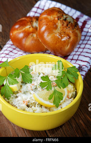plate with salad and bread rolls at the village table Stock Photo